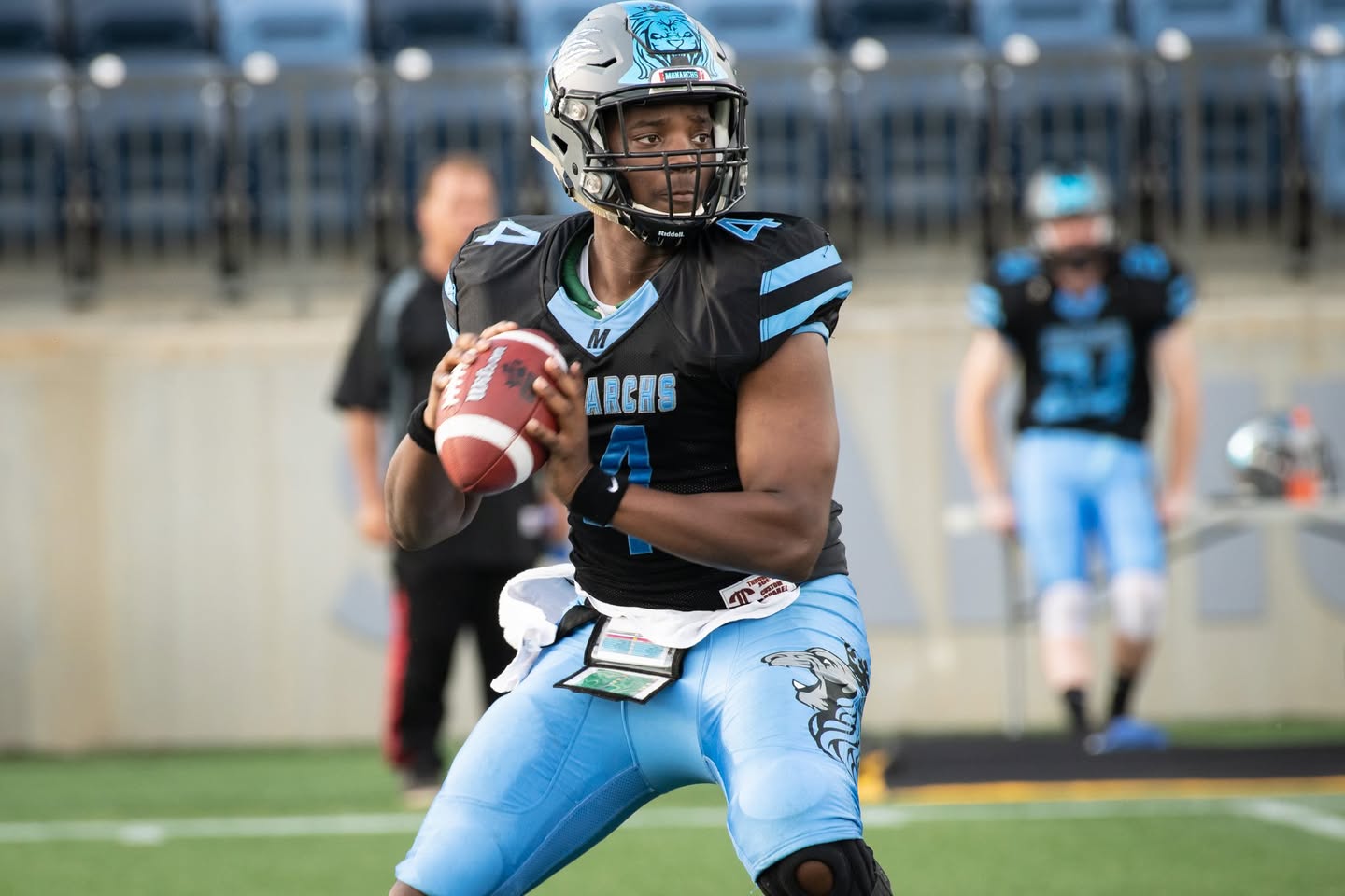 Monarchs quarterback dropping back to pass vs Calgary Wolfpack