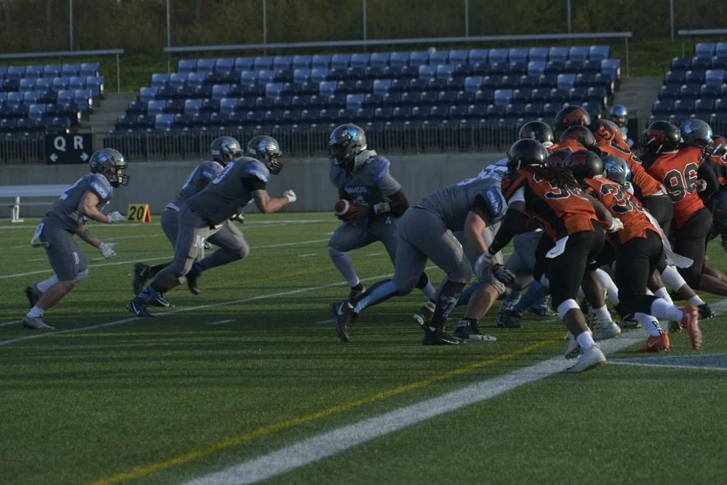Monarchs offensive line driving off the snap