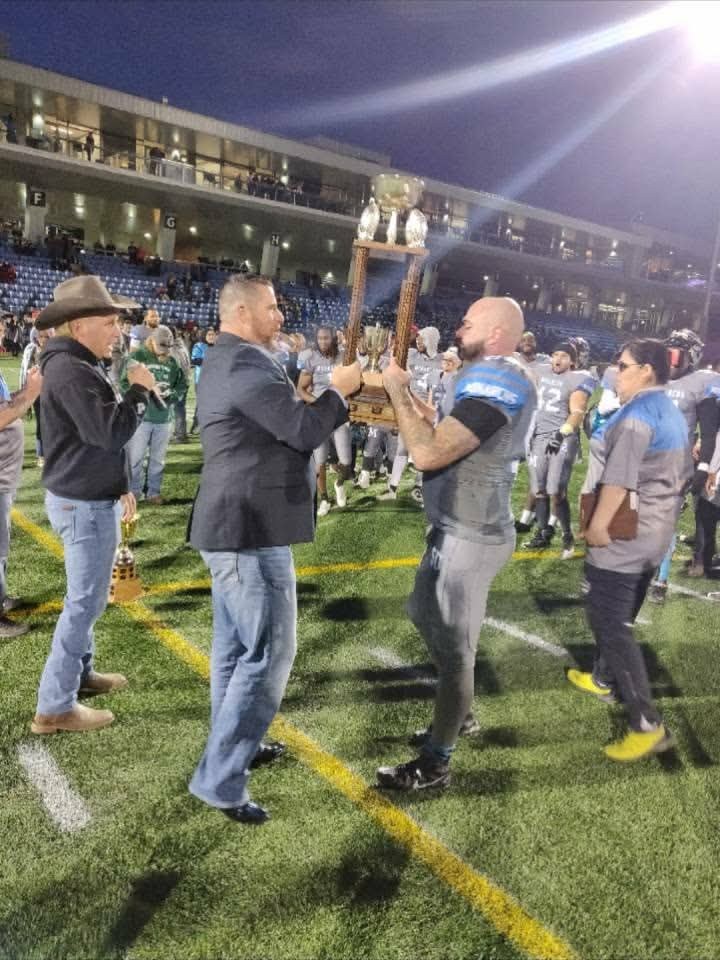 Monarchs receiving the championship trophy on the field