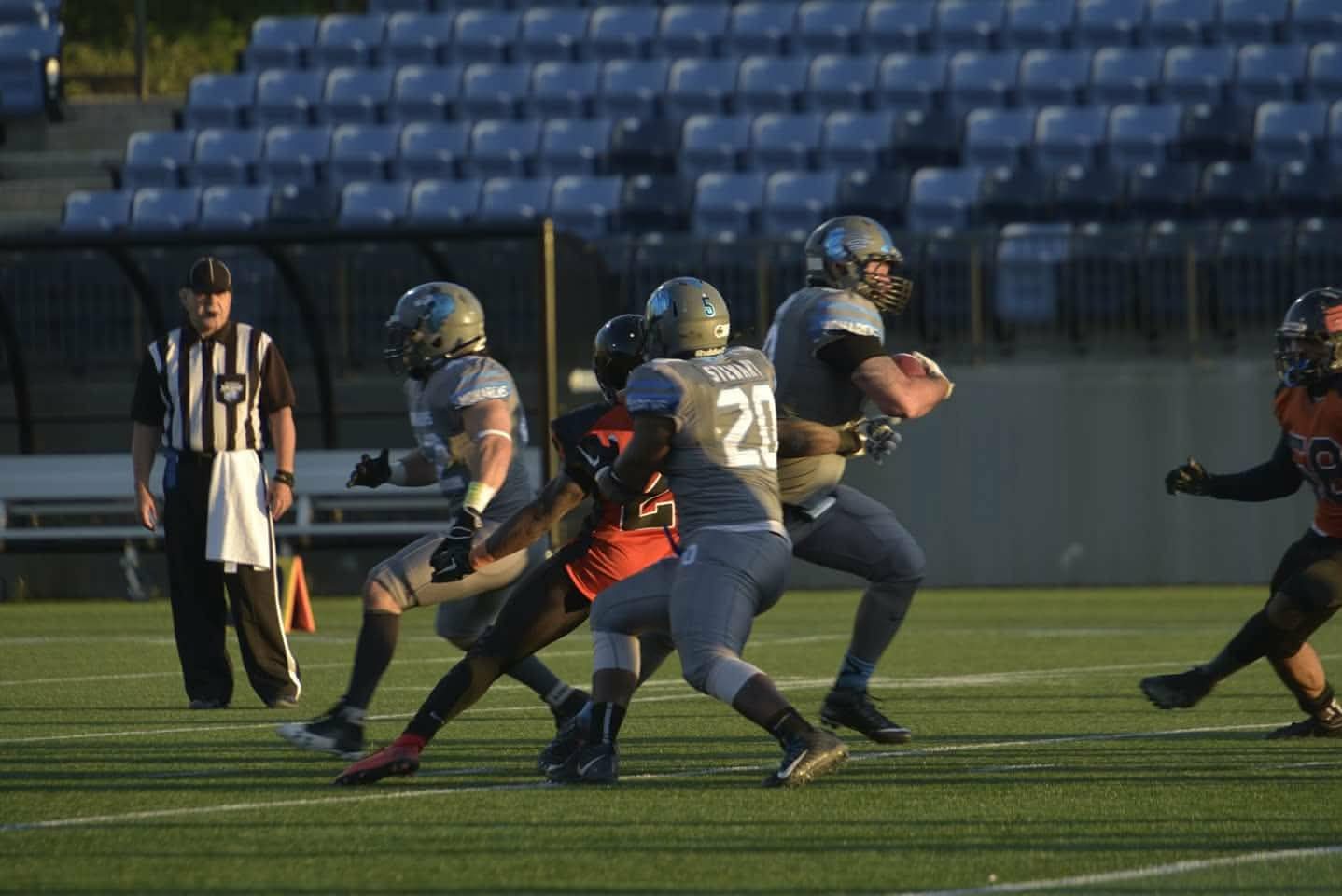 Monarchs running back breaking through a tackle at SMS Equipment Stadium